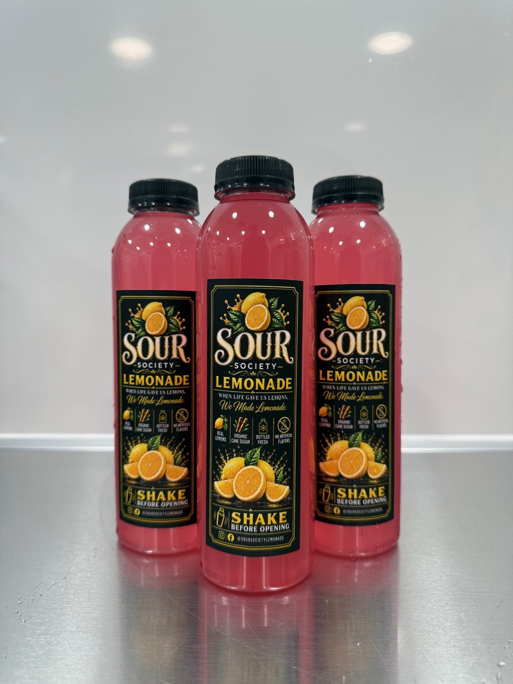 Three bottles of pink Sour Society lemonade