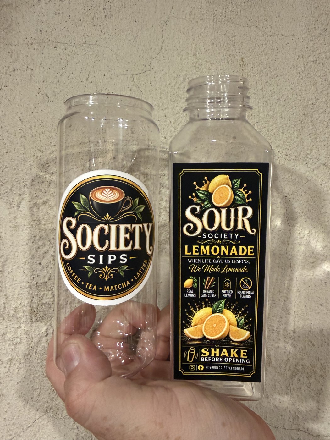 The Society Sips can and Sour Society lemonade bottle